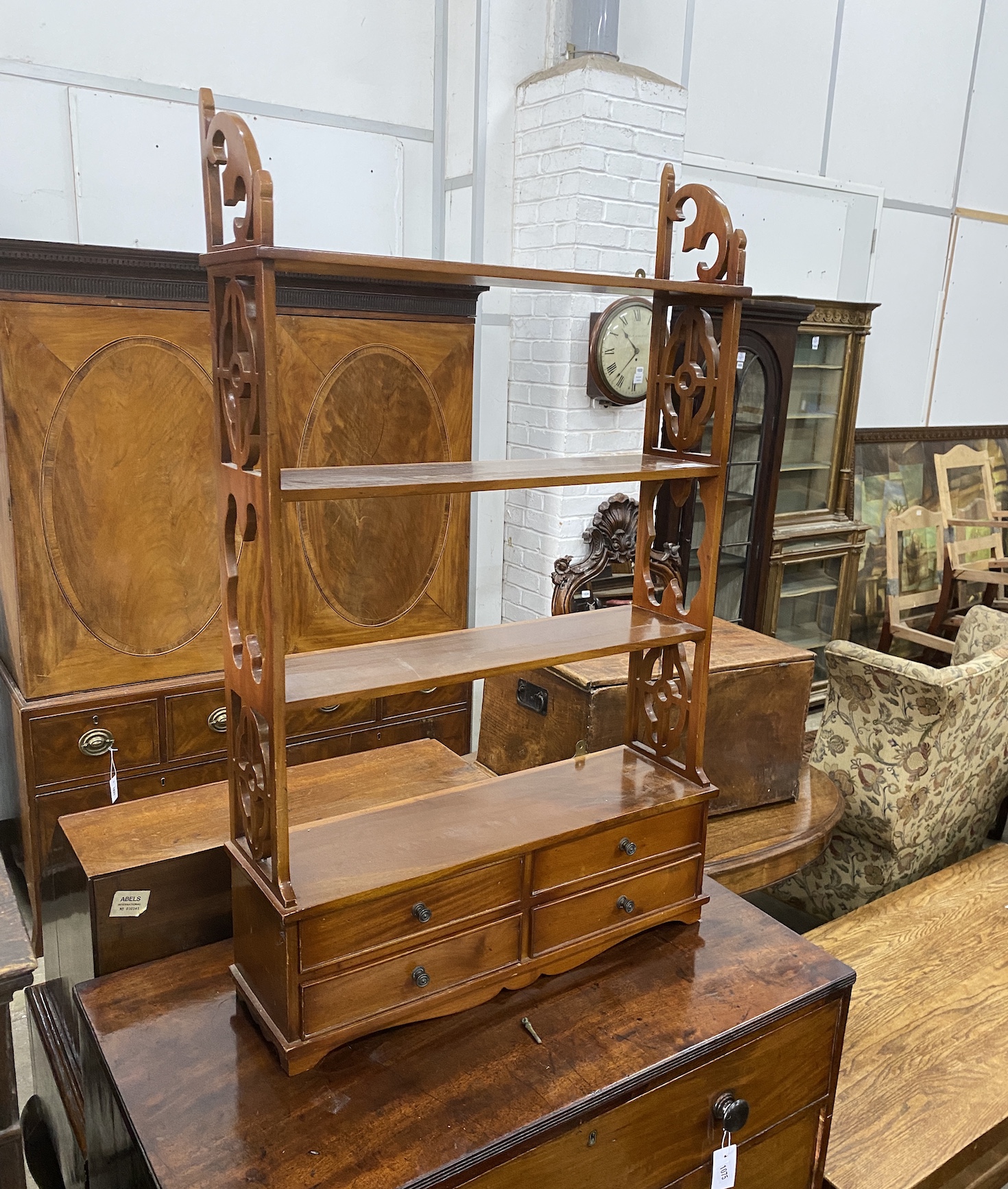 A reproduction George III style mahogany four tier wall bracket, the base fitted with two drawers, width 69cm, depth 20cm, height 111cm